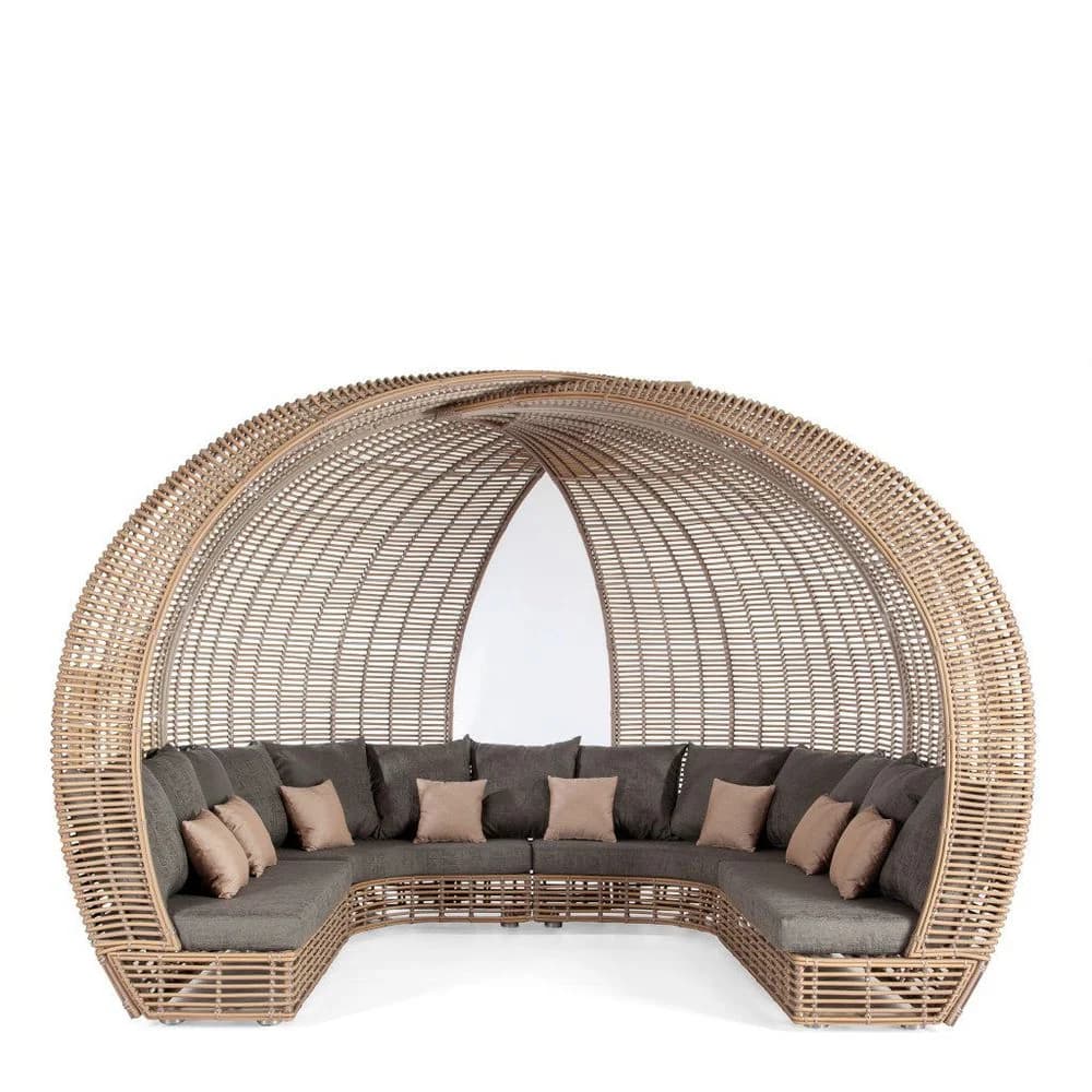 Rattan lounge chair with a woven side table and pendant lamp in a warm, light interior
